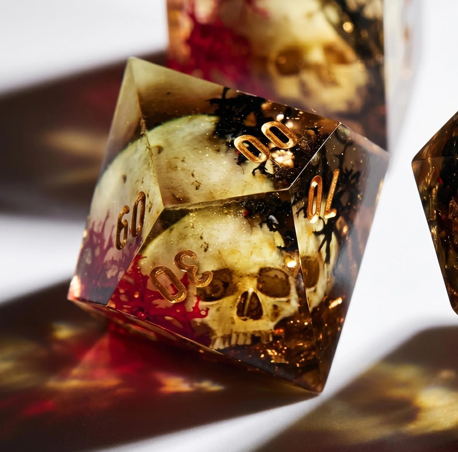 Ossuary Echoes dice set, skulls in crystal resin with crimson accents